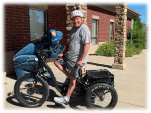 Bill Ludlow on his power road trike in front of The Sight Center