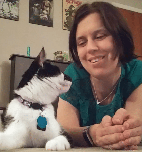 Super cute black and white cat looks up at his person that loves him very much