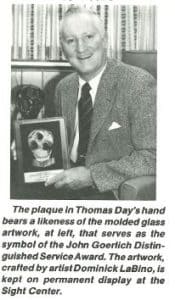 Tom Day holds award