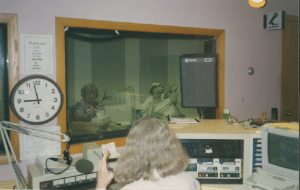 forground woman counts down.... far background, 2 women reading the news