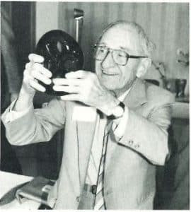 John Goerlich holds the award that was designed by Dominick Labino. 