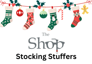 a colorful assortment of hanging stockings. Text: The shop Stocking Stuffers