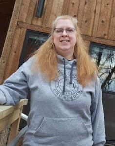 a picture of a woman in a grey hoodie